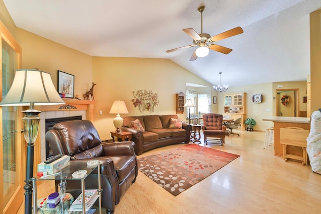 2506 Woodridge Ln, Brainerd, MN 56401 - living area with a ceiling fan, wood finished floors, lofted ceiling, a chandelier, and a tiled fireplace