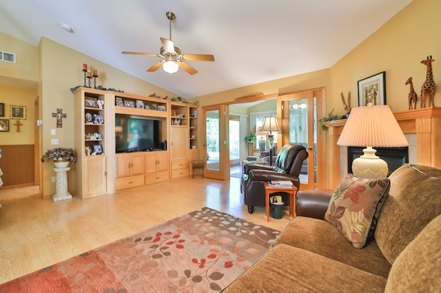 2506 Woodridge Ln, Brainerd, MN 56401 - living room featuring wood finished floors, lofted ceiling, ceiling fan, and a fireplace