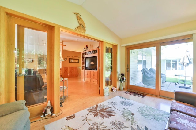 2506 Woodridge Ln, Brainerd, MN 56401 - living room featuring vaulted ceiling, wood finished floors, and wainscoting