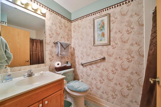2506 Woodridge Ln, Brainerd, MN 56401 - bathroom with vanity, toilet, a textured ceiling, wallpapered walls, and baseboards