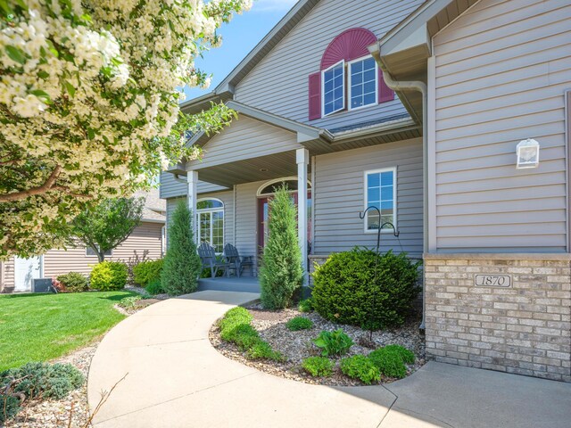 view of front of home with a porch and a front yard