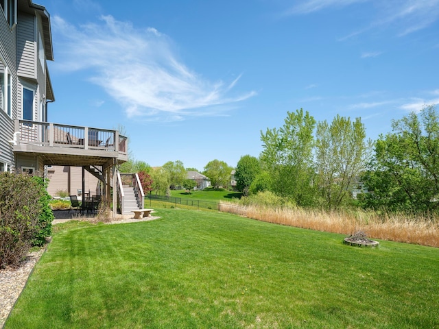 view of yard featuring stairs and a wooden deck