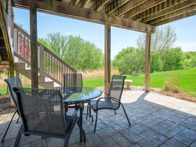 view of patio / terrace featuring outdoor dining area and stairway