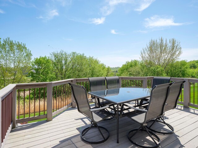 wooden deck featuring outdoor dining area