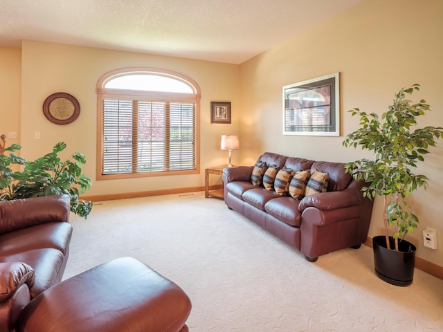 carpeted living room with baseboards