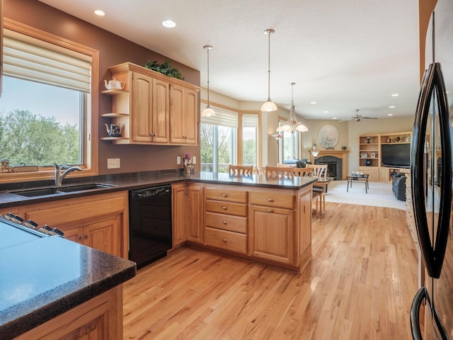 kitchen with black appliances, a sink, light wood-type flooring, a ceiling fan, and recessed lighting
