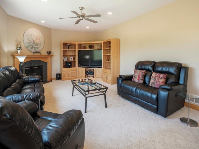 living area with a ceiling fan, light colored carpet, recessed lighting, a high end fireplace, and baseboards