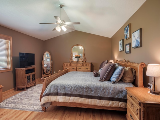 bedroom with wood finished floors, lofted ceiling, and a ceiling fan