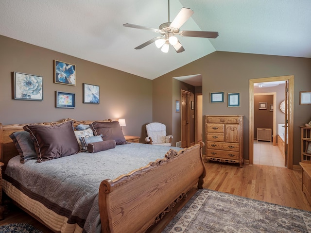 bedroom featuring vaulted ceiling, light wood finished floors, a ceiling fan, and radiator heating unit