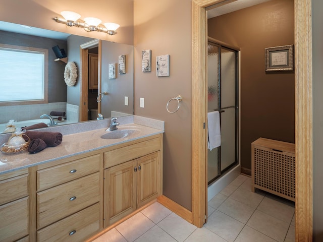 full bathroom with a shower stall, tile patterned flooring, vanity, radiator, and baseboards