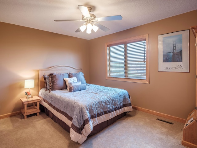 bedroom featuring carpet floors, baseboards, and a ceiling fan