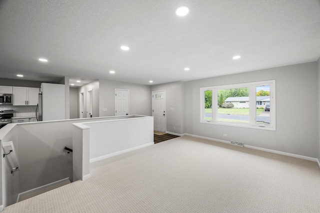 3213 63rd Ave N, Brooklyn Center, MN 55429 - kitchen with stainless steel appliances, carpet, baseboards, recessed lighting, and white cabinetry