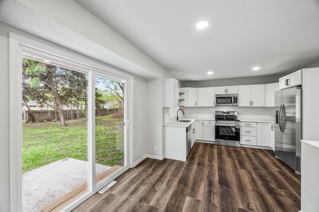3213 63rd Ave N, Brooklyn Center, MN 55429 - kitchen with appliances with stainless steel finishes, a sink, light countertops, decorative backsplash, and dark wood finished floors