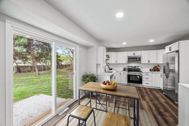 3213 63rd Ave N, Brooklyn Center, MN 55429 - kitchen featuring appliances with stainless steel finishes, a sink, light countertops, backsplash, and white cabinets