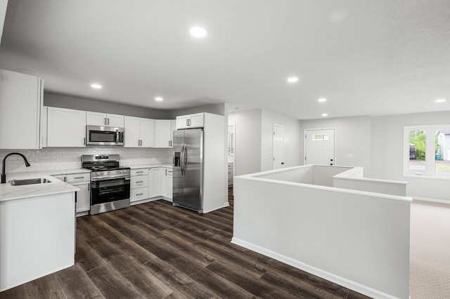 3213 63rd Ave N, Brooklyn Center, MN 55429 - kitchen featuring stainless steel appliances, a sink, recessed lighting, backsplash, and dark wood-style flooring