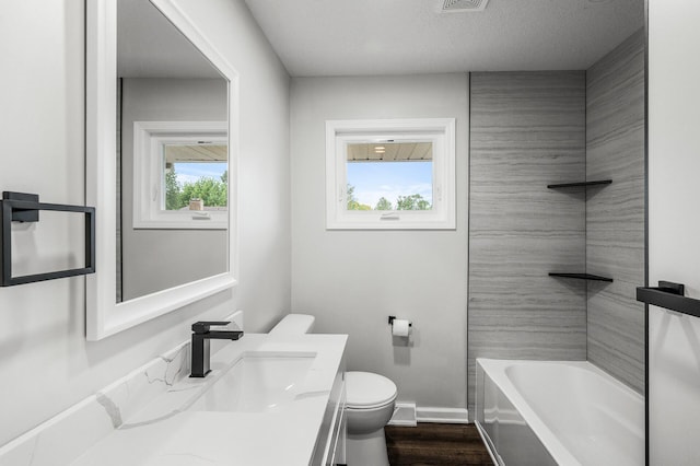 3213 63rd Ave N, Brooklyn Center, MN 55429 - full bath with toilet, vanity, baseboards, and wood finished floors