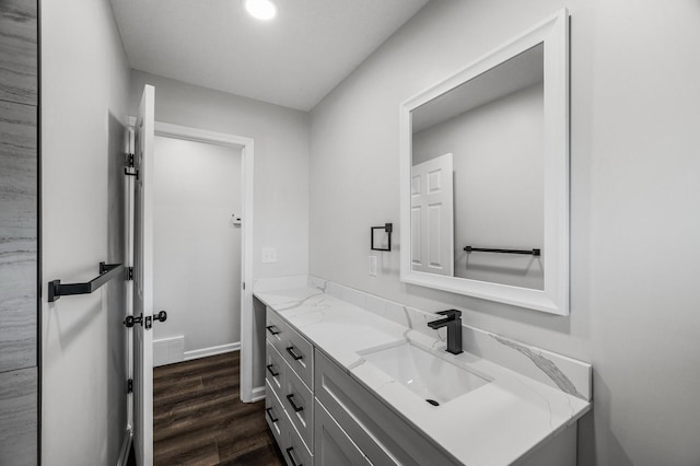 3213 63rd Ave N, Brooklyn Center, MN 55429 - bathroom with vanity, wood finished floors, and baseboards