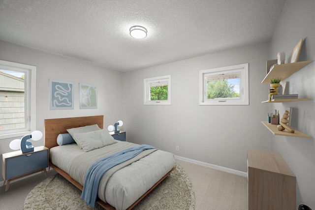 3213 63rd Ave N, Brooklyn Center, MN 55429 - bedroom with carpet floors, a textured ceiling, and baseboards