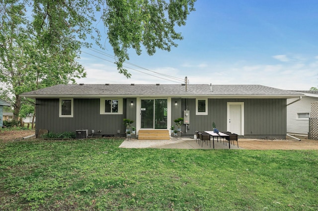 3213 63rd Ave N, Brooklyn Center, MN 55429 - rear view of house with a patio area, a lawn, entry steps, and central AC