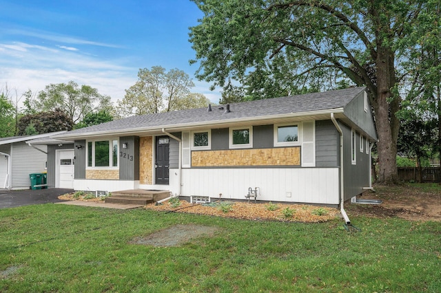 3213 63rd Ave N, Brooklyn Center, MN 55429 - ranch-style house featuring a front lawn, stone siding, and driveway