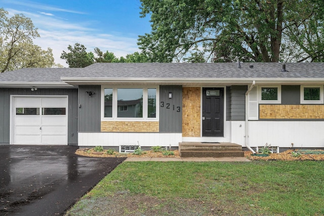 3213 63rd Ave N, Brooklyn Center, MN 55429 - ranch-style house featuring an attached garage, a front lawn, stone siding, roof with shingles, and driveway