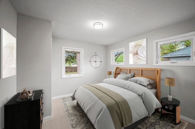 3213 63rd Ave N, Brooklyn Center, MN 55429 - bedroom featuring carpet floors, baseboards, and a textured ceiling