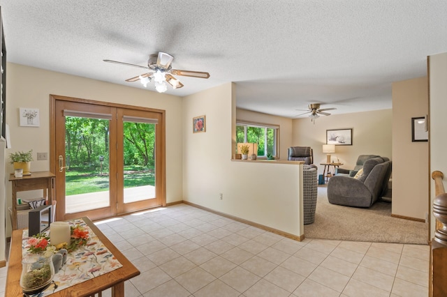 19375 181st Ave NW, Big Lake Twp, MN 55309 - living area featuring a ceiling fan, light colored carpet, baseboards, light tile patterned floors, and a textured ceiling
