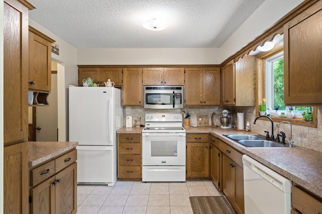 19375 181st Ave NW, Big Lake Twp, MN 55309 - kitchen featuring white appliances, a sink, tasteful backsplash, a textured ceiling, and brown cabinetry