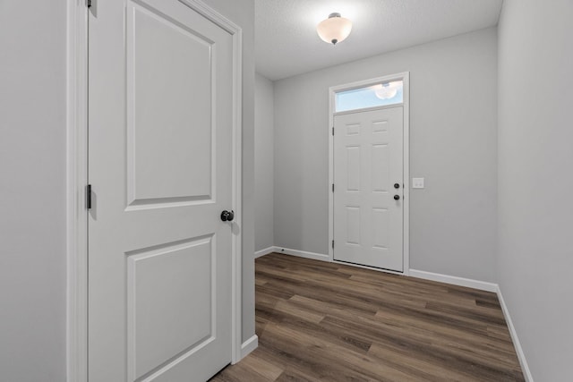14617 Quintana St NW, Ramsey, MN 55303 - entrance foyer featuring baseboards, dark wood finished floors, and a textured ceiling