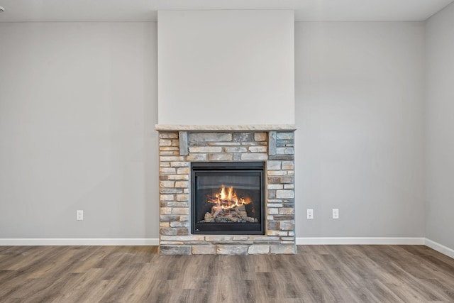 14617 Quintana St NW, Ramsey, MN 55303 - detailed view of a fireplace, wood finished floors, and baseboards