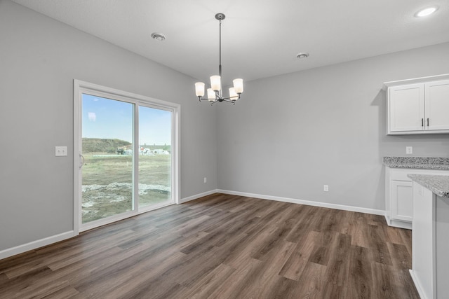 14617 Quintana St NW, Ramsey, MN 55303 - unfurnished dining area with dark wood finished floors, a chandelier, baseboards, and recessed lighting