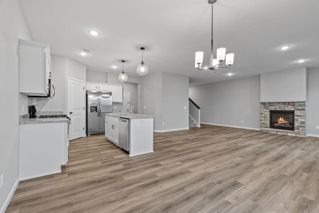 14617 Quintana St NW, Ramsey, MN 55303 - kitchen featuring stainless steel appliances, open floor plan, baseboards, and recessed lighting