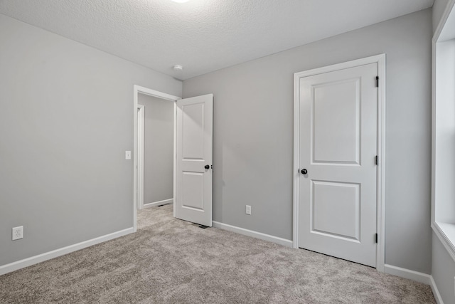 14617 Quintana St NW, Ramsey, MN 55303 - unfurnished bedroom featuring carpet flooring, a textured ceiling, and baseboards