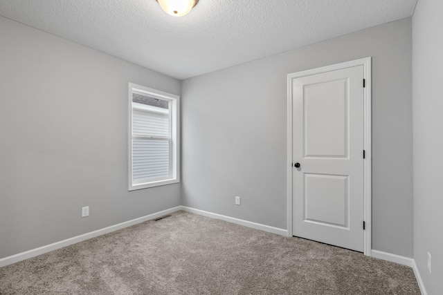 14617 Quintana St NW, Ramsey, MN 55303 - spare room featuring carpet flooring, a textured ceiling, and baseboards