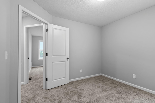 14617 Quintana St NW, Ramsey, MN 55303 - unfurnished room featuring carpet flooring, a textured ceiling, and baseboards