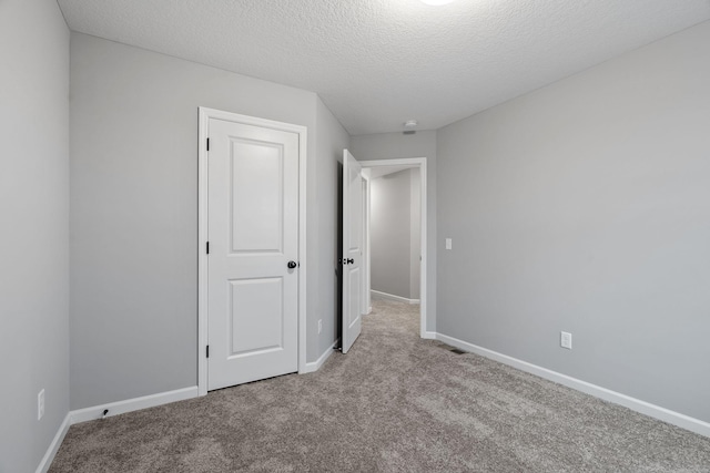 14617 Quintana St NW, Ramsey, MN 55303 - unfurnished bedroom with carpet, a textured ceiling, and baseboards