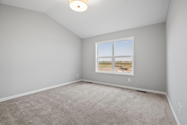 14617 Quintana St NW, Ramsey, MN 55303 - unfurnished room featuring lofted ceiling, carpet, and baseboards