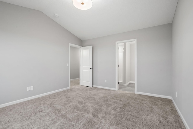14617 Quintana St NW, Ramsey, MN 55303 - unfurnished bedroom featuring vaulted ceiling, carpet floors, and baseboards