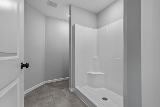 14617 Quintana St NW, Ramsey, MN 55303 - full bath featuring a shower, tile patterned flooring, baseboards, and a textured ceiling