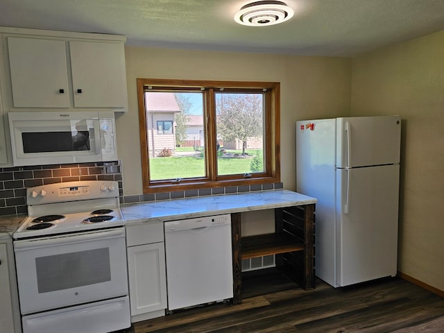 2729 King Ave, Slayton, MN 56172 - kitchen featuring white appliances, dark wood-style floors, tasteful backsplash, white cabinetry, and light stone countertops