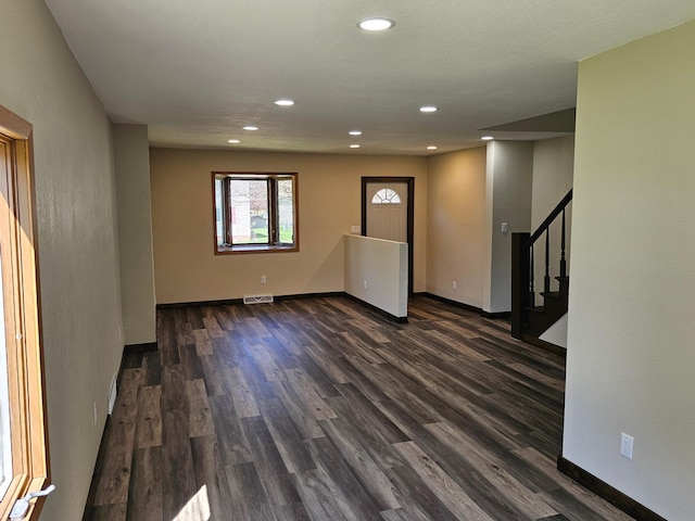 2729 King Ave, Slayton, MN 56172 - spare room with dark wood-style flooring, recessed lighting, stairs, and baseboards