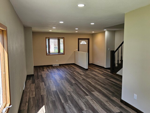2729 King Ave, Slayton, MN 56172 - unfurnished living room with dark wood-style flooring, recessed lighting, baseboards, and stairway
