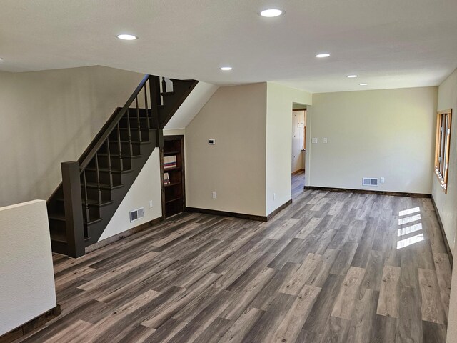 2729 King Ave, Slayton, MN 56172 - unfurnished living room with wood finished floors, stairway, recessed lighting, and baseboards