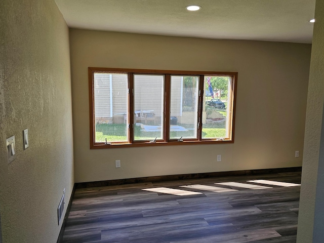 2729 King Ave, Slayton, MN 56172 - unfurnished room with wood finished floors, recessed lighting, a textured wall, and baseboards