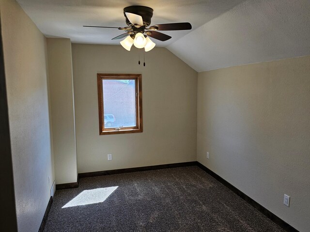 2729 King Ave, Slayton, MN 56172 - bonus room featuring dark carpet, ceiling fan, lofted ceiling, and baseboards