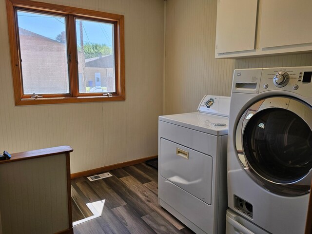2729 King Ave, Slayton, MN 56172 - washroom featuring washing machine and dryer, cabinet space, dark wood-type flooring, and baseboards