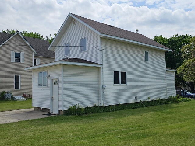 2729 King Ave, Slayton, MN 56172 - view of side of home featuring a lawn and a patio area