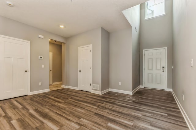 foyer entrance with wood finished floors, baseboards, and recessed lighting