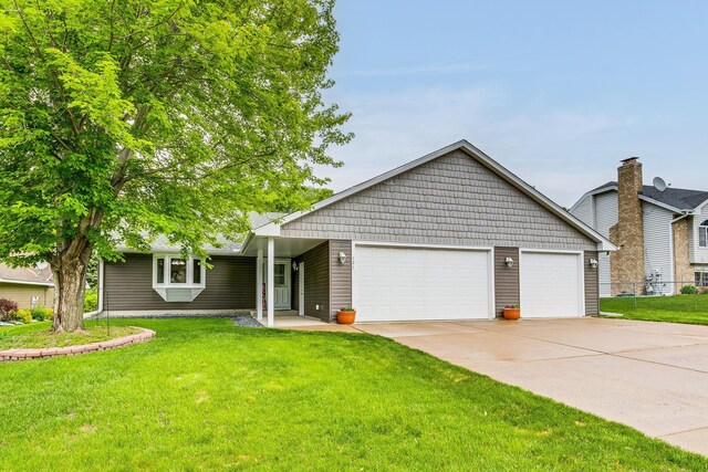 121 Yorkton Rdg, Little Canada, MN 55117 - view of front of home with an attached garage, concrete driveway, and a front yard