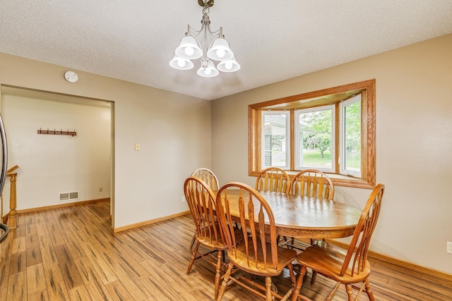 121 Yorkton Rdg, Little Canada, MN 55117 - dining room with a chandelier, light wood finished floors, and baseboards
